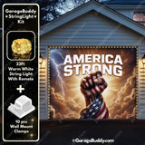 Patriotic garage door banner with 'America Strong' text, fist wrapped in US flag, and string lights.