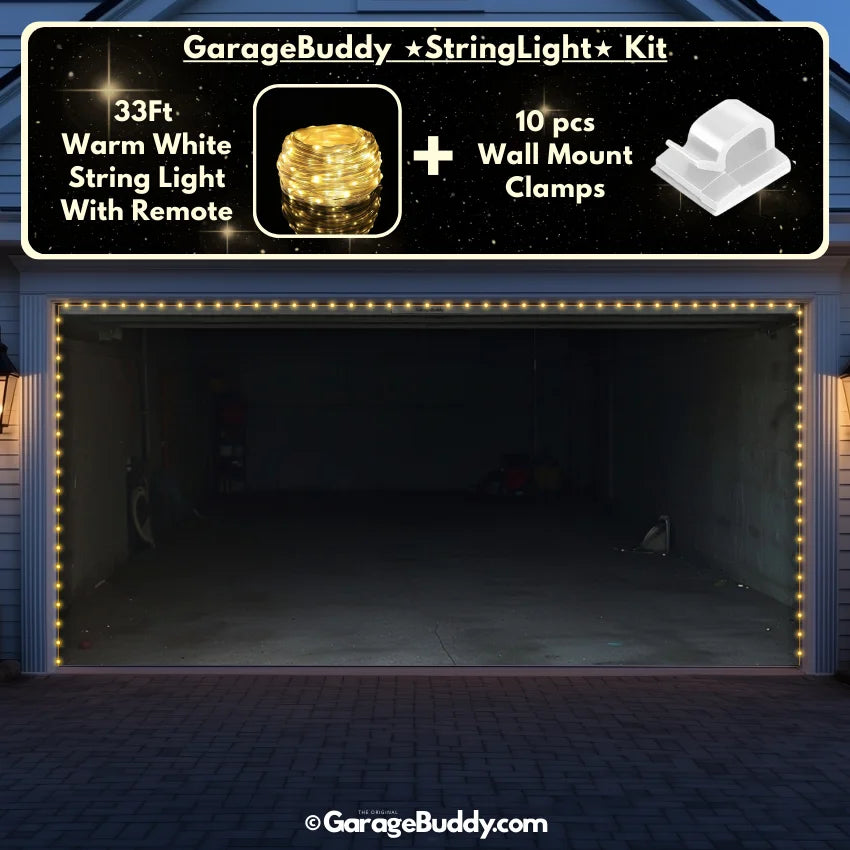An empty double-door garage door cover illuminated by decorative string lights outlining the garage doors and roofline. The interior is clean and spacious, with no vehicles or items inside.
